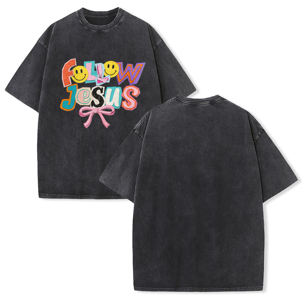 Christianartworkshop Follow Jesus Smile Bow Color Block Letter Washed Unisex T-Shirt - Black - 5XL - image 1